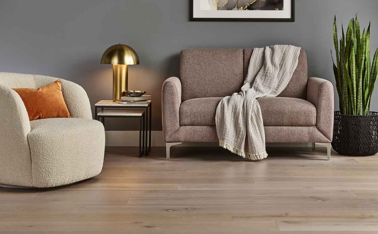Hardwood flooring in a living room with loveseat and accent chair